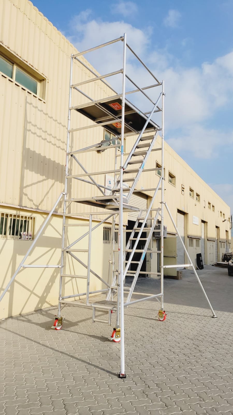 Industrial aluminium access platform installed inside a manufacturing facility.