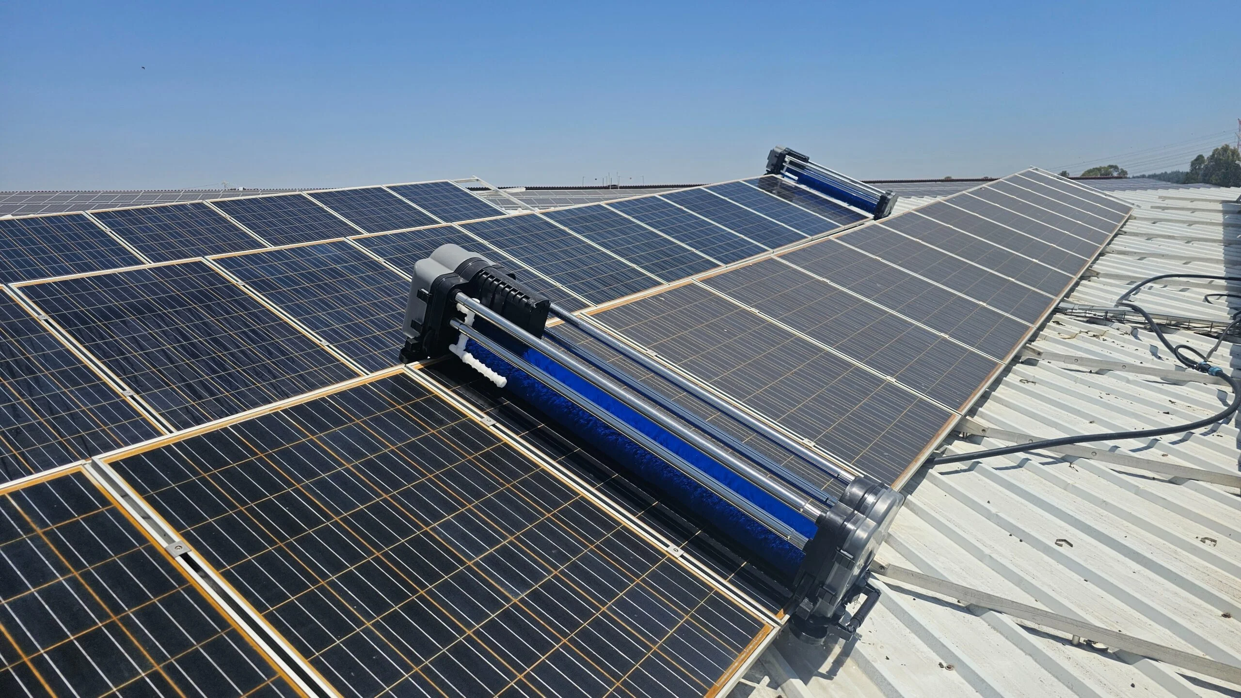 Autonomous solar panel cleaning robot operating on a large-scale solar farm in the UAE desert environment.